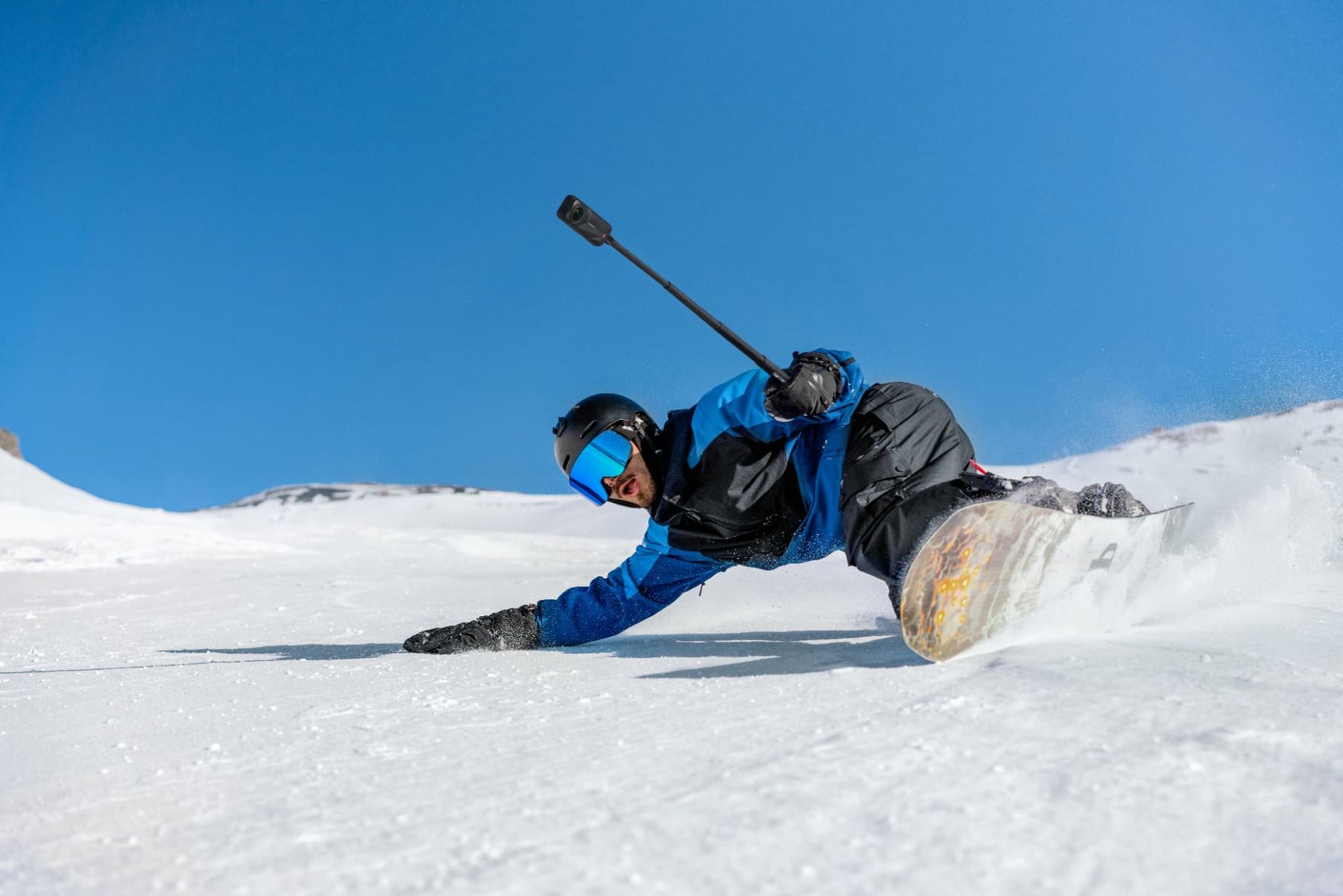 Snowboarder carving powder snow filming with an X5